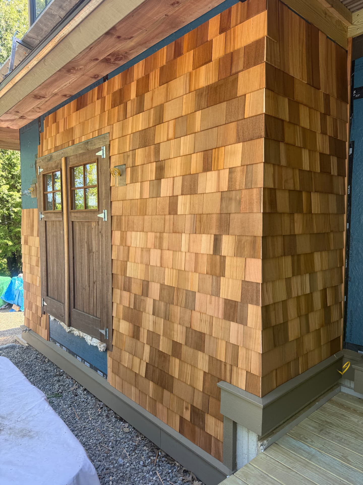 Natural cedar shake siding wrapping the corner of a new addition