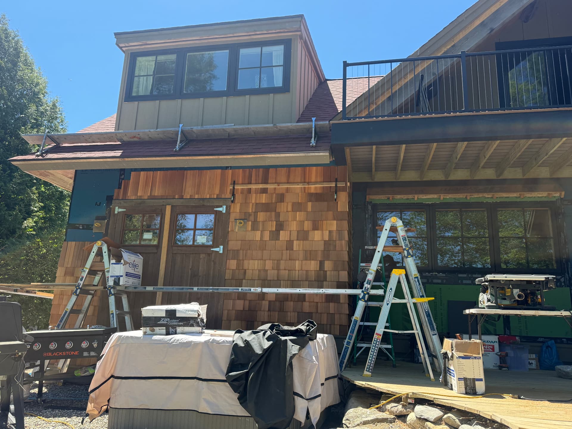 Exterior siding and trim work underway on a two story home