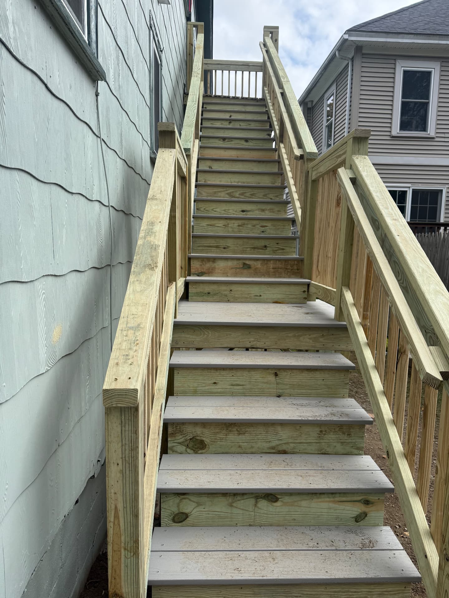 Finished stairway with composite treads and pressure treated railings