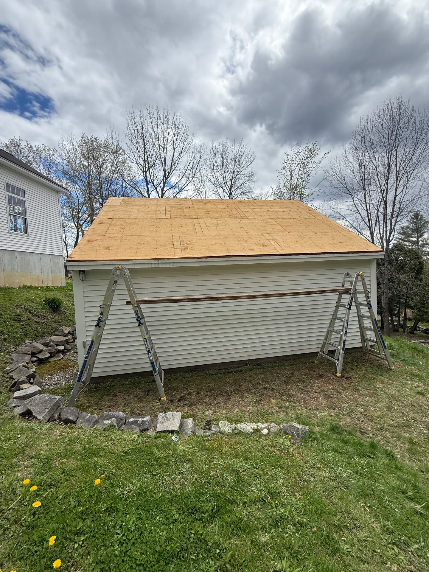 Detached garage stripped to new roof sheathing during a roof replacement