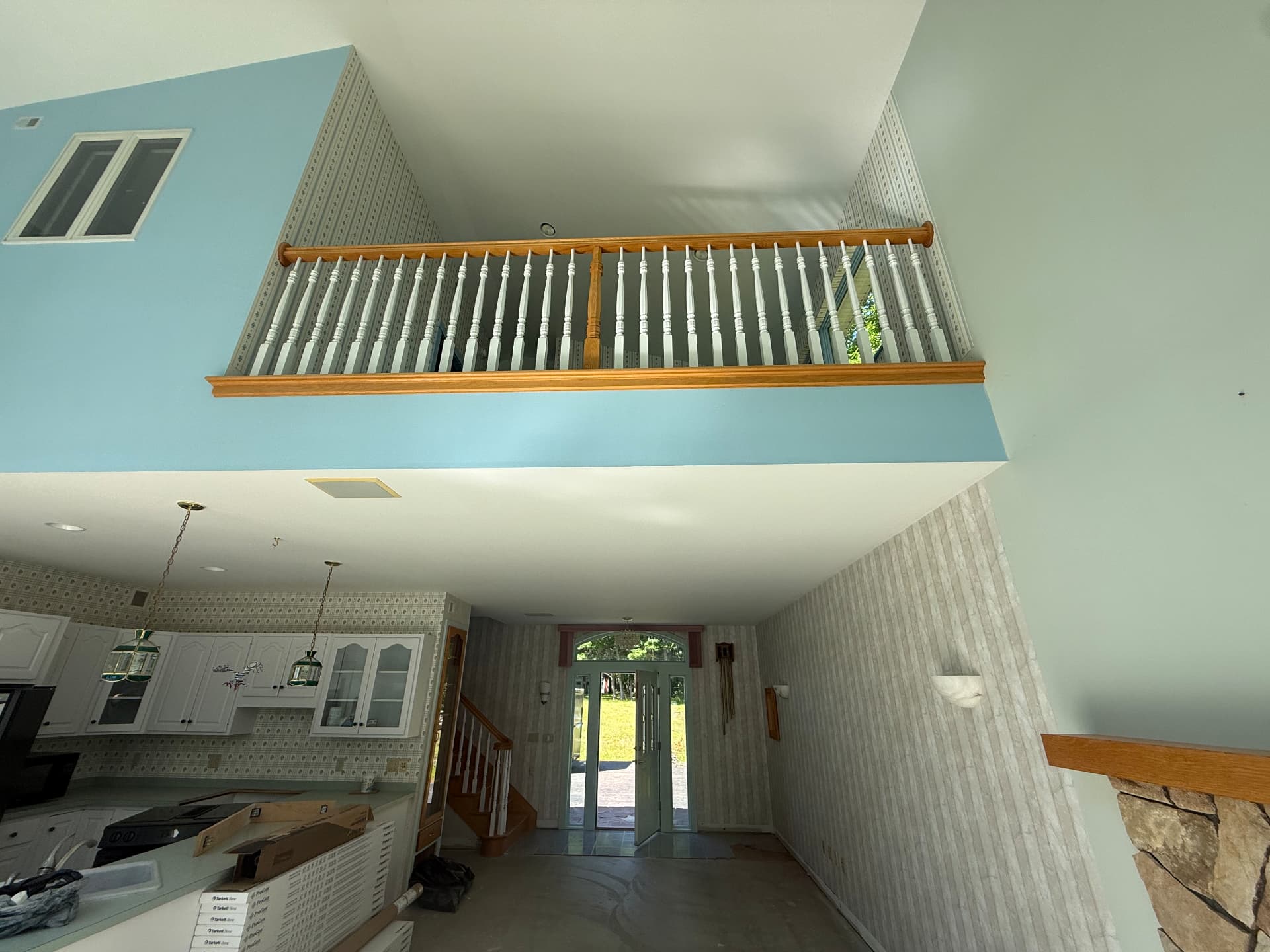 Interior loft railing and vaulted ceiling during a full home renovation