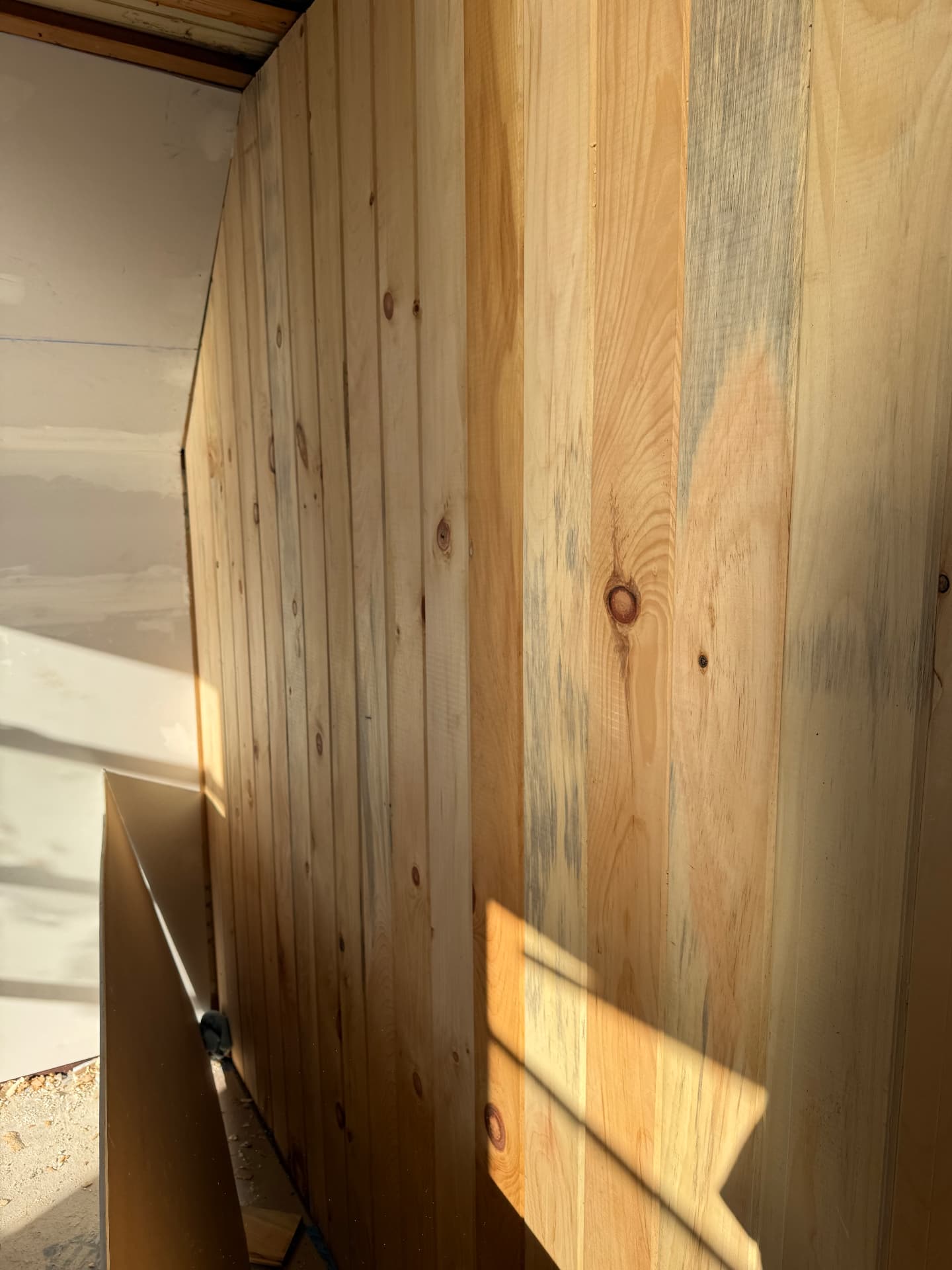 Interior pine tongue and groove paneling installed on a stairwell wall